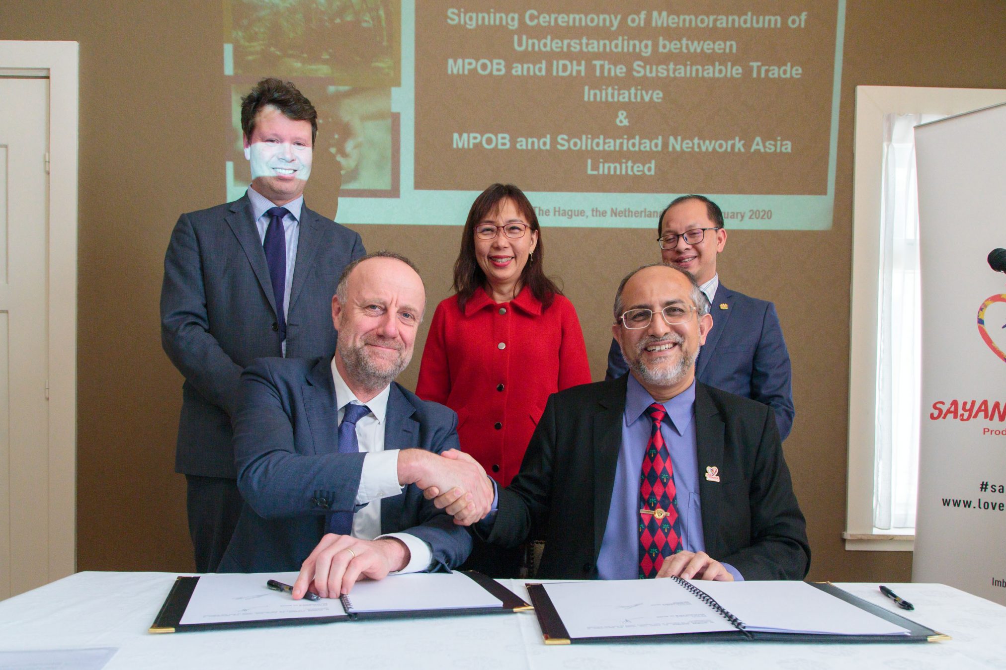 Joost Oorthuizen (IDH) and Dr. Ahmad Parveez Ghulam Kadir (Malaysian Palm Oil Board) sign an MoU on sustainable palm oil, witnessed by Teresa Kok, Minister for Primary Industries of Malaysia